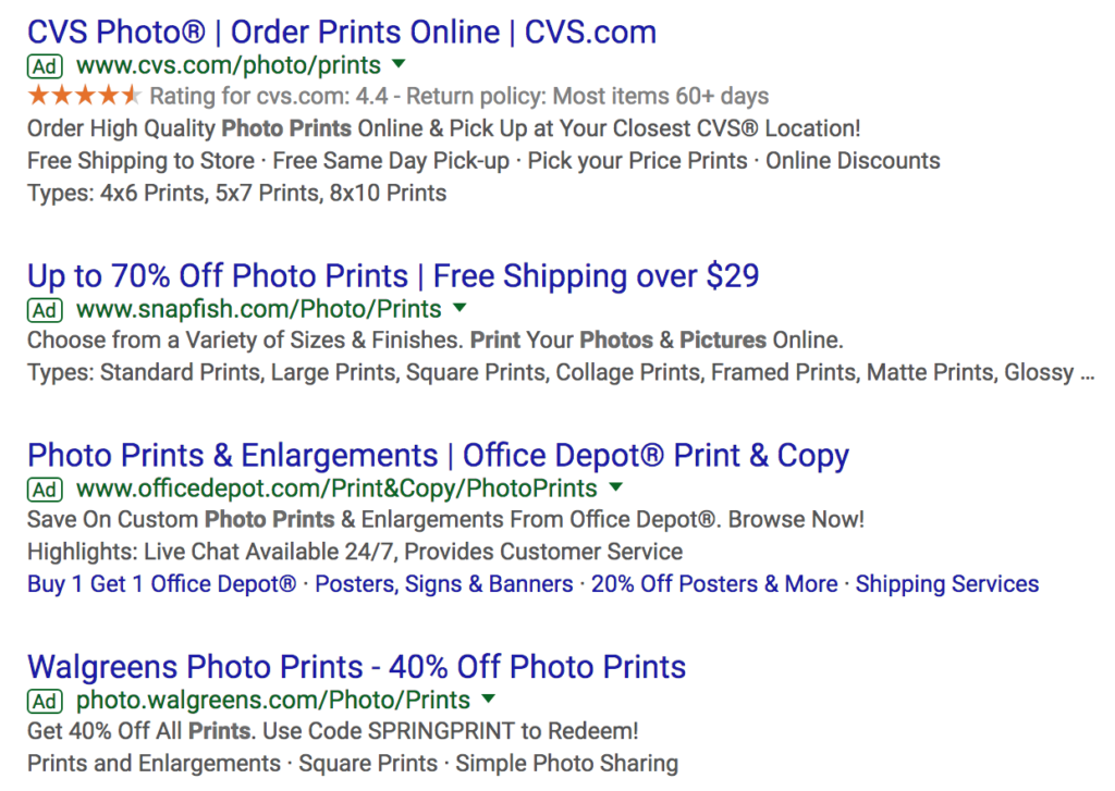 Google search ad copy about photo prints with the percentage off in their headlines.