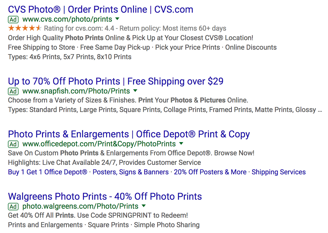 Google search ad copy about photo prints with the percentage off in their headlines.