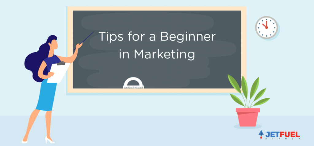 A teacher pointing at a black board with "tips for a beginner in marketing" written.